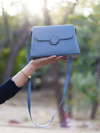 Elegant Blue Sling Bag with Round Metal Accent