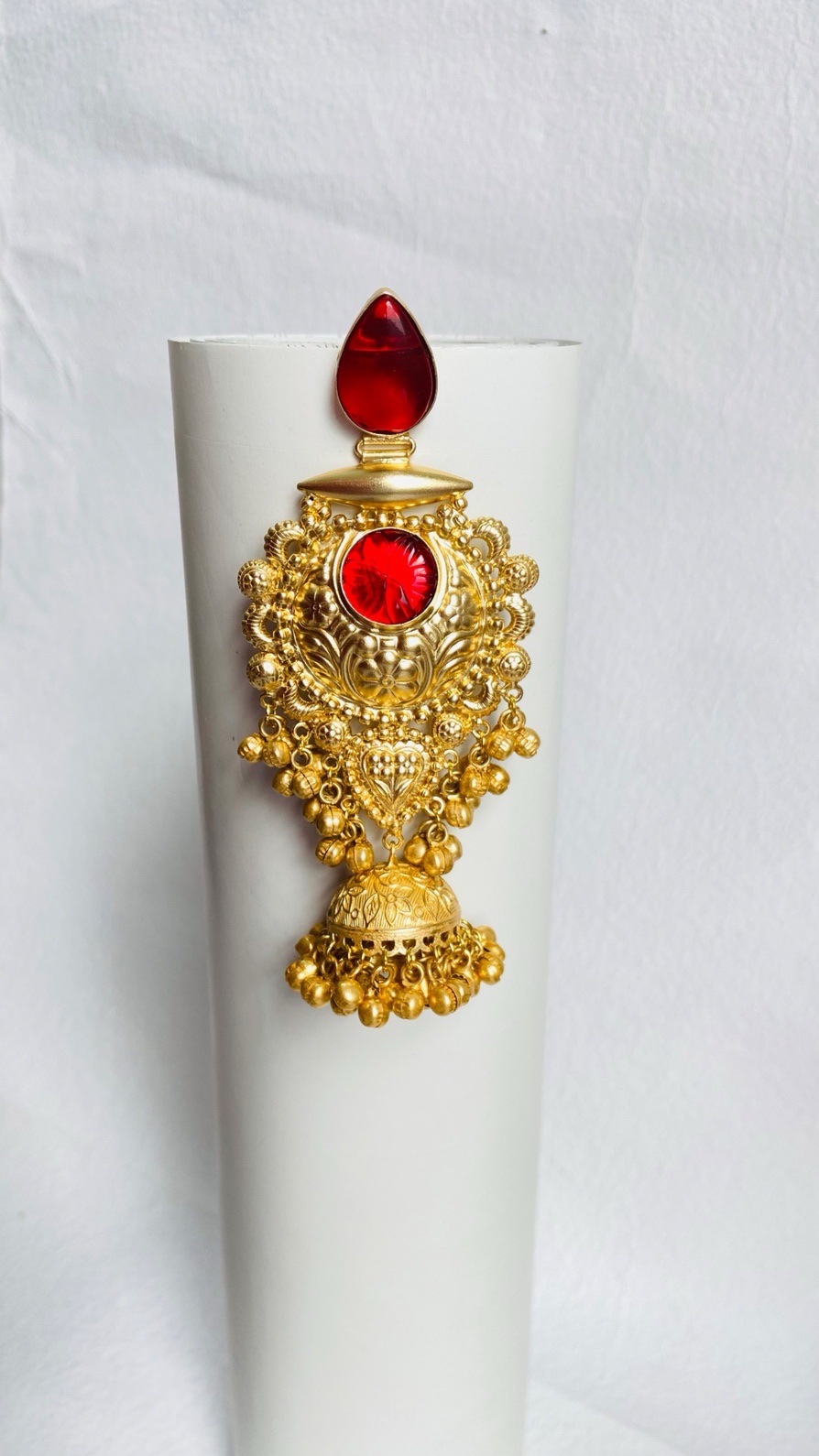 Timeless gold-plated red jhumka earrings with intricate detailing and a regal touch.